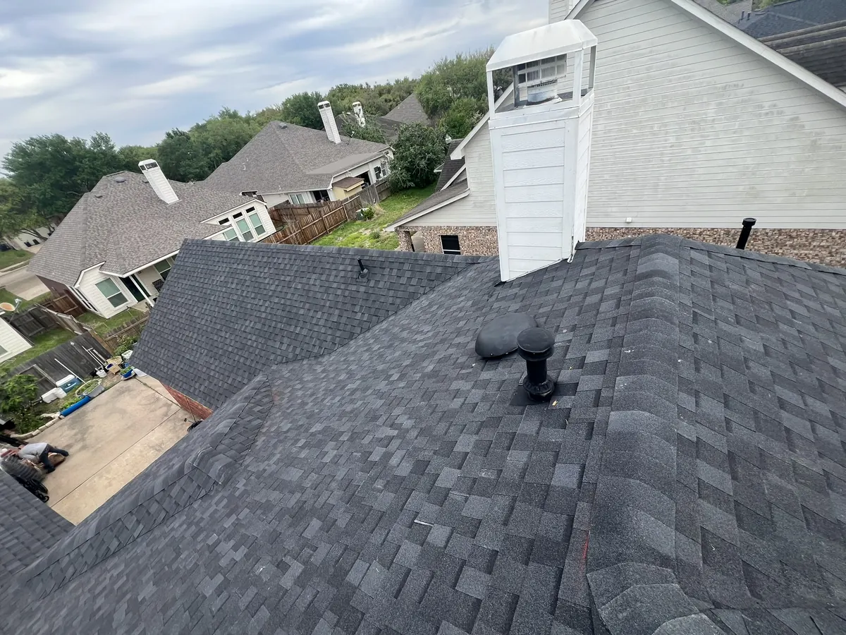 New dark shingles and roof vents on the finished roof in Katy, TX