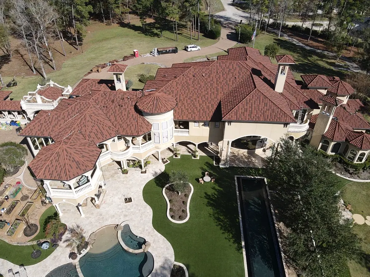 Completed DECRA metal roof on a Mediterranean-style villa in Magnolia, TX