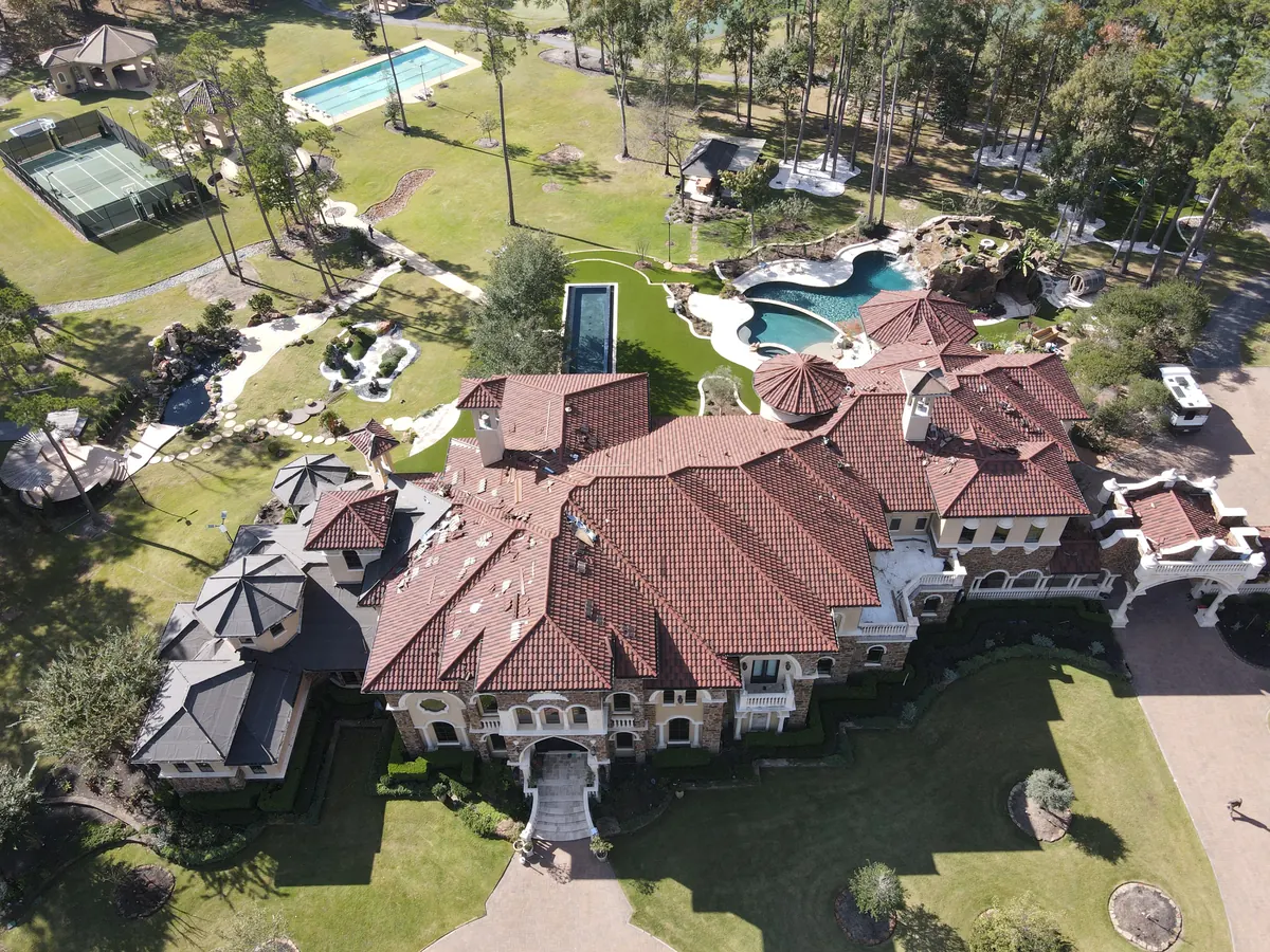 Clay tile to DECRA metal roof conversion in progress on a Magnolia, TX villa