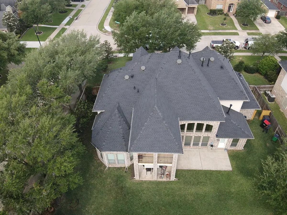 Completed charcoal shingle roof on a two-story home in Sugar Land, TX